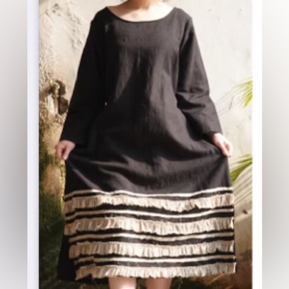 Black linen dress with ruffle trim.